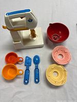 Full set laid out showing mixer, bowl, utensils, icing pieces