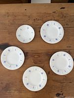 Group view of three dessert plates and saucer