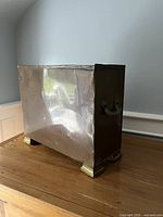 Front and side view showing copper body, brass feet, side handle