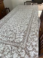 Full view of lace tablecloth covering dining table