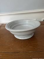 Top view of white ironstone footed dish showing shallow bowl form