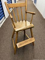 Full view of wooden child’s highchair