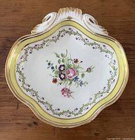 Top view showing floral center, yellow border, gold trim