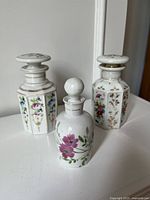 Three porcelain scent bottles with stoppers