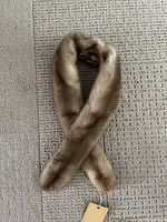 Full view of crossed mink scarf showing overall length and colour