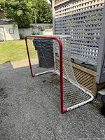 Three-quarter view of entire hockey net showing frame and netting