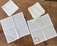 Both stacks of napkins plus two opened showing each design