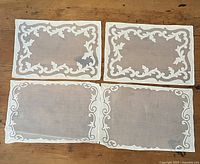 Four placemats laid out showing two distinct border designs