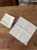 One napkin unfolded beside stacked napkins