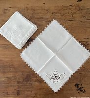Stack of folded napkins and one opened to show full size and design
