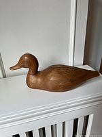 Side view of carved pine duck