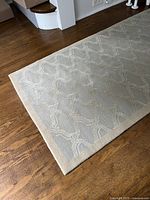 Full view of wool runner rug showing color, pattern and beige trim