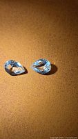 Both pear-cut aquamarines side by side