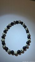 Full view of bracelet showing alternating Dalmatian jasper and black onyx beads