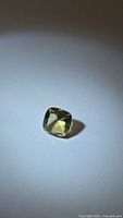 Cushion-cut golden citrine on neutral background
