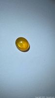 Front view of oval golden yellow sapphire cabochon