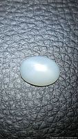 Top view of oval white star moonstone showing centred star