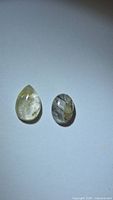 Pear and oval rutilated quartz cabochons side by side