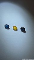 Trio of sapphires: two blue ovals, one yellow pear