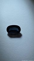 Oval blue spinel front view on neutral background