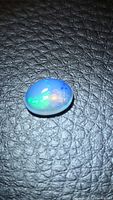 Top view of oval cabochon opal showing play-of-color