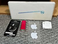 Group shot of all items: boxed keyboard, power bank, PopSockets mount, EarPods case, two Apple stickers