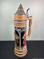 Full view of tall German beer stein with lid