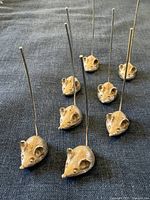 Full set of eight Napier mouse cheese picks displayed on dark fabric