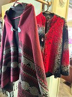 Poncho and jacket hanging side by side showing overall appearance