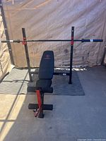Full view of Marcy weight bench with uprights and barbell