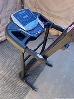 Overall view of folded Merax treadmill showing console and frame