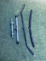 All three workout bars laid out on turf for size comparison