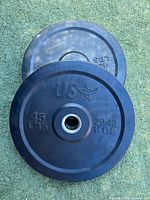 Two stacked black USA 45 lb bumper plates