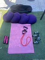 All items laid out: mat, cushions, resistance band, push-up bars, weights, bag