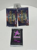 All three sealed packs displayed front side