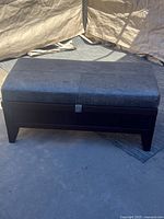 Front view of wood base and gray faux leather top