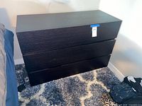 Front view of dresser next to bed