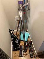 Full view of Dyson V7 vacuum with wand and accessories on floor