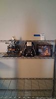 Full lot on shelf showing LEGO lunar lander and two Star Wars tins