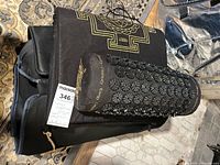 Mat and pillow stacked showing gold print and discs