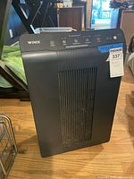 Front view of Winix 5500-2 air purifier showing grille and brand logo