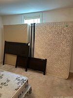 Headboard, footboard, mattress, box spring, metal rails leaning against wall