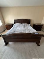 Full view of queen sleigh bed with leather headboard and footboard