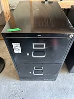 Front view showing two drawers, handles, label frames, lock cylinder, HON badge