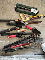 Lot overview showing all garden tools laid out