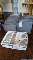 Nine-piece Urban Home bin set and two grey mesh folder organizers on floor