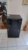 Front view of black compact fridge