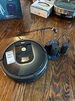 Roomba vacuum with dock, power cord and two virtual wall towers