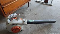 Full view right side of Stihl BG 50 blower with tube attached on concrete floor