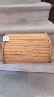 Front view of pine roll-top bread box closed